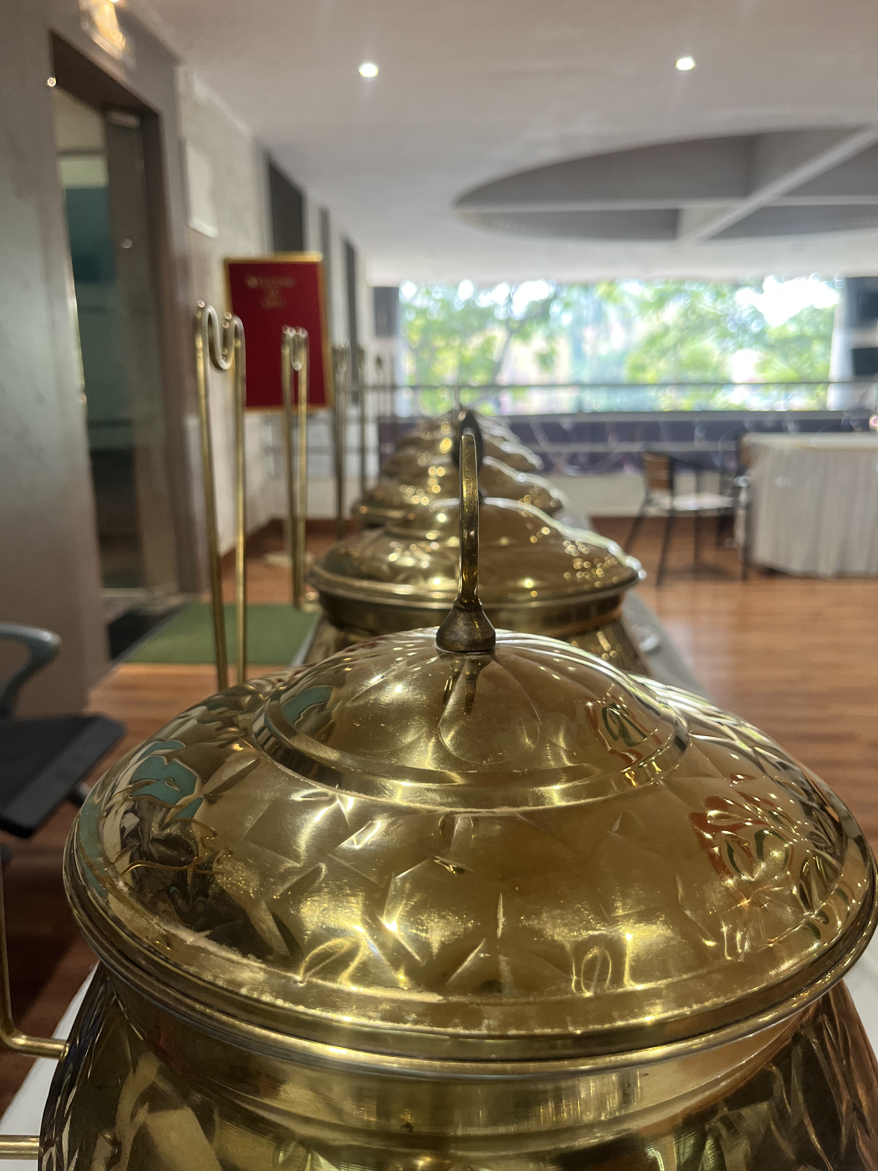 A vibrant Mumbai catering spread with lights, flowers and celebration food