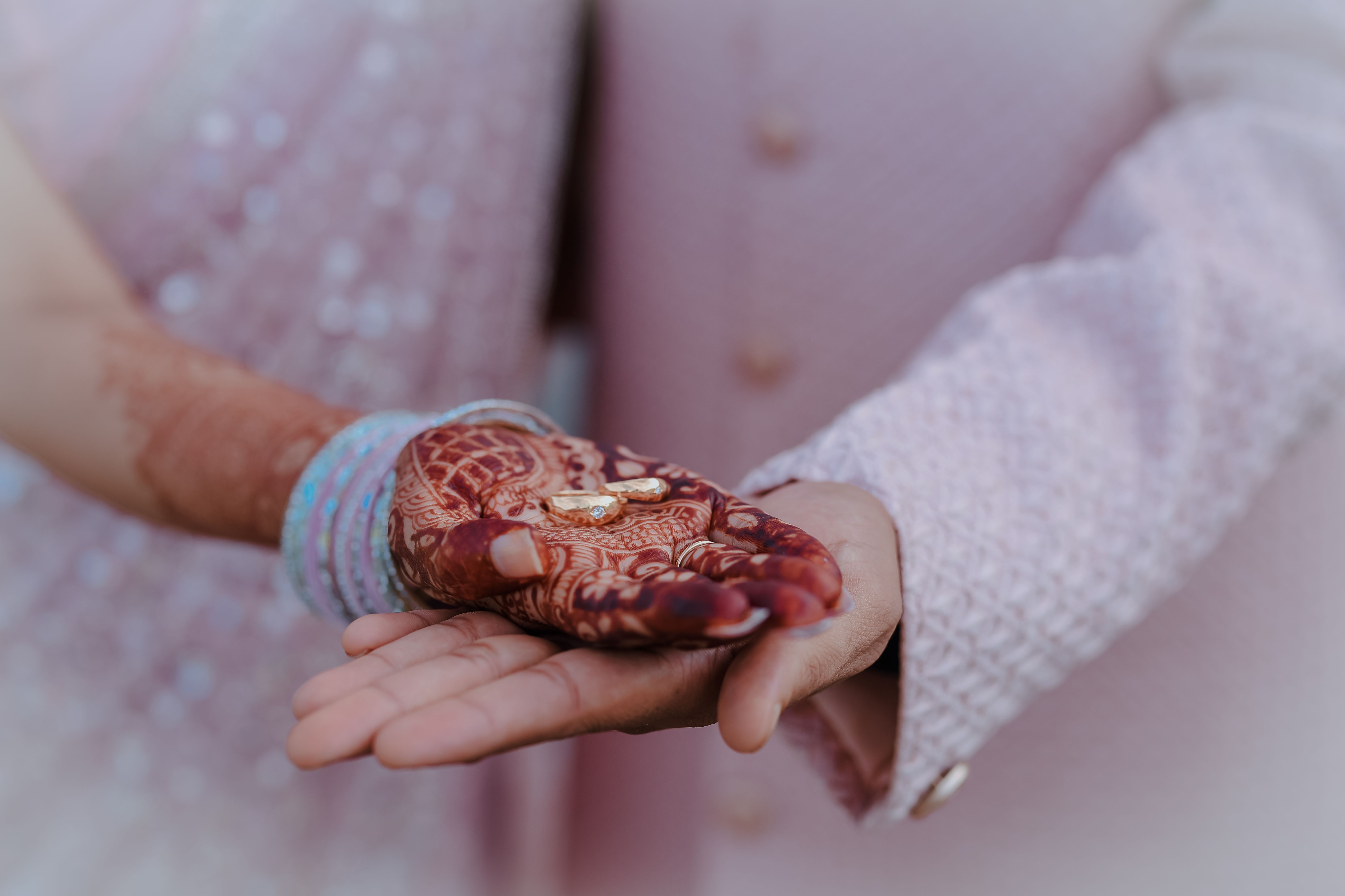 Indian engagement ring ceremony under a marigold rose arch