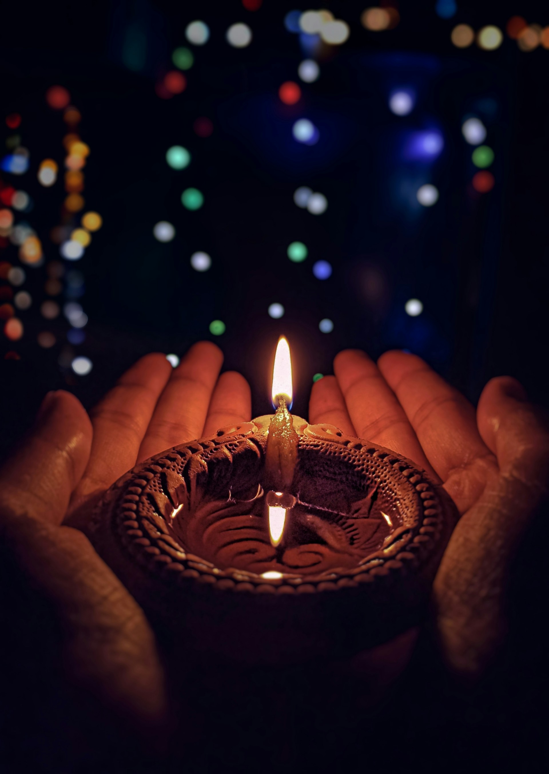 Rows of glowing brass diyas in a sacred Indian pooja setup